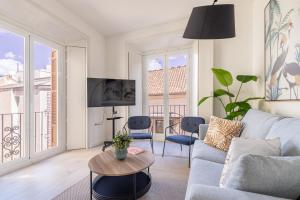 a living room with a couch and a table at Thyssen Boutique Apartments by Caleta Homes in Málaga