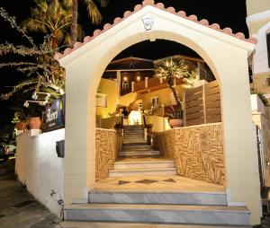 an archway leading up to a building with stairs at Heaven Apartments in Agia Marina Nea Kydonias