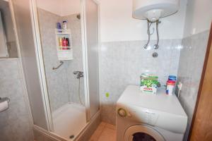 a small bathroom with a toilet and a shower at House Sun and Sea in Olib +18 photos