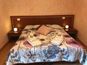 a bedroom with a bed with two towels on it at Locanda della Corte in Roccamorice