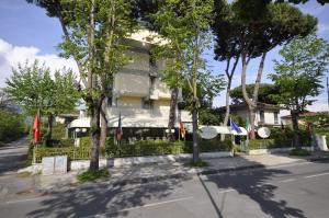 a building with flags in front of it at Hotel Airone in Marina di Pietrasanta