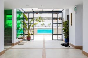 a hallway with plants and a swimming pool at Caleyro Boutique Apartments - "Parking incluido" in Fuengirola