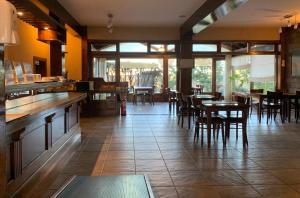 a restaurant with tables and chairs in a room at Patagonia Queen Hotel Boutique in El Calafate