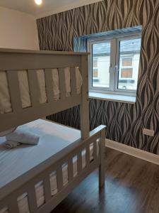 a bedroom with two bunk beds and a window at 8 Eyre Square Lane in Galway