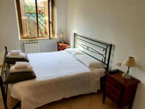 ein Schlafzimmer mit einem großen weißen Bett und einem Fenster in der Unterkunft Dream House Fiumicino in Fiumicino