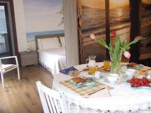 a dining room with a table with food on it at Casa Laura in Terracina