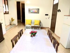 - une salle à manger avec une table et des fleurs dans l'établissement CASA VACANZA BariSardo, à Bari Sardo