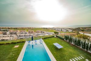 an overhead view of a swimming pool in a yard with buildings at Villa Agadir Taghazout Bay Beach & Golf View in Taghazout