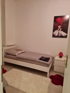 a bedroom with a bed and a picture on the wall at Schönstes Wohnen nahe Hagen Eilpe in Hagen