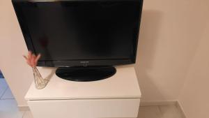 Telewizor siedzący na białej szafce w obiekcie Il Gelso w mieście Pimonte +14 zdjęć