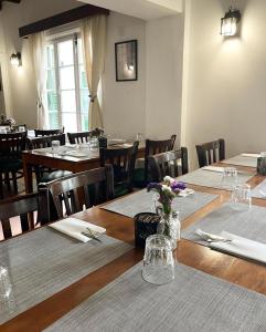 a dining room with tables and chairs with flowers on them at Semiramis Hotel in Platres