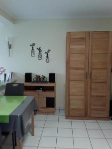a room with a table and a wooden cabinet at Ferienappartement Wagner in Zell an der Mosel
