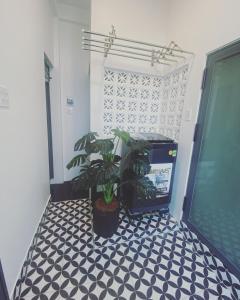 a room with a black and white tiled floor with a plant at LILY HOUSE( Mini home 2PN) in Quy Nhon +25 photos