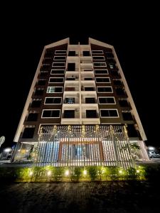 a tall building with a gate in front of it at night at PadiViu Family Suite at Imperio Professional Suite, Alor Setar in Alor Setar