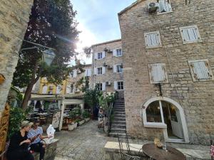 a group of people sitting outside of a building at Beatrix Suites in Budva