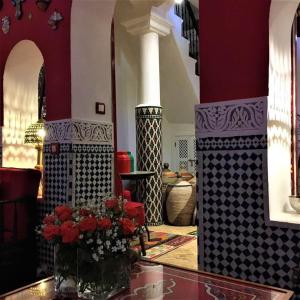 a lobby with a vase of flowers on a table at Dar Sultan in Tangier