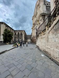 a group of people walking around a building at Apartament Ciraulo in Catania