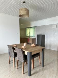 a dining room table with chairs and a kitchen at Western Ocean Breeze Self Catering in Victoria