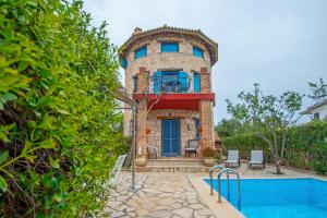 a house with a pool in front of it at Valory's Houses - The Tower in Vasilikos
