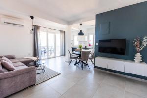 a living room with a couch and a tv at Apartments Rising Sun, Ražanac in Ražanac