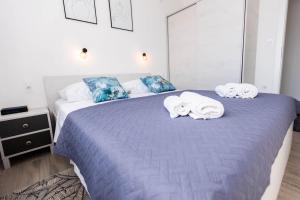 a bedroom with two towels on a bed at Apartments Rising Sun, Ražanac in Ražanac