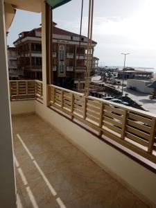 a balcony with a wooden railing and a view of a city at Villa 29 - Marouf Group in Ras El Bar