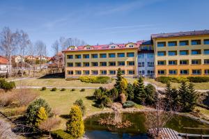 a large building with a garden and a pond at Private Luxury Apartments in Frymburk