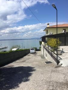 a car parked in a parking lot next to the water at CASA COSTA AL SOLE in Lazise
