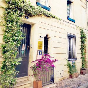 a building with flowers on the side of it at La Belle Endormie B&B French Guest house in Bordeaux