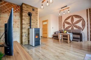a living room with a fireplace and a tv at Tatras Residence in Poronin