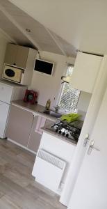 a kitchen with white appliances and a stove top oven at Ferme de Chiuni in Cargèse +35 photos