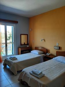 Postel nebo postele na pokoji v ubytování Ammousa Hotel Apartments