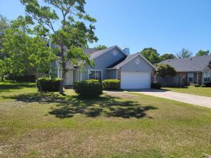 a house with a driveway and a garage at Five Minutes From the Beach in Navarre