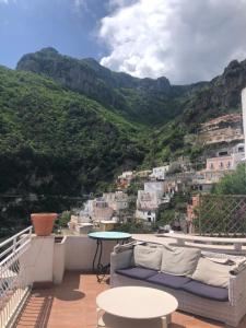 a balcony with a view of the mountains at Hostel Brikette in Positano