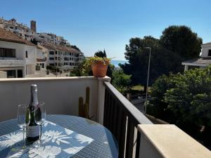 a bottle of wine sitting on a table on a balcony at Piso Alcosta Piteras in Altea