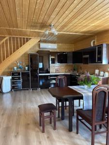 a kitchen and dining room with a table and chairs at Villa OCTOPUS in Dąbki