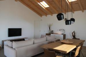 a living room with a couch and a table at Quinta do Planalto Vicentino - Casas de Campo in Aljezur