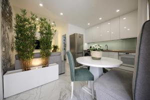 a kitchen with a white table and some plants at Dina Beach House Avó Mariana in Nazaré