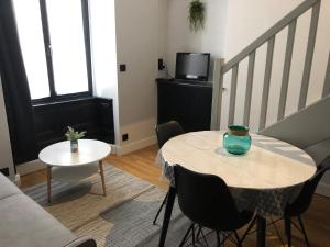 a living room with a table and a couch at DUPLEX COSY HYPER CENTRE CHOLET in Cholet