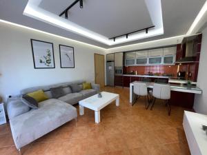 a living room with a couch and a table at Saranda Central Apartment in Sarandë