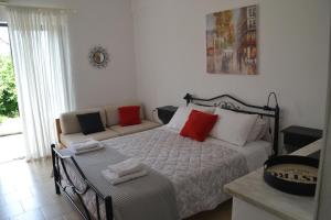 a bedroom with a bed and a couch at A Place to Relax 2 in Nisakion