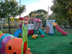 a childrens playground with a play set on the grass at Il Mirto Residence in Marina di Camerota