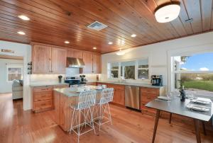 een keuken met houten kasten en een houten plafond bij The Beach House 2 home in Anna Maria