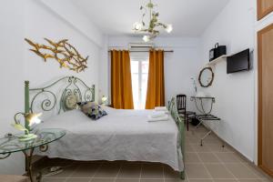 Ένα ή περισσότερα κρεβάτια σε δωμάτιο στο Pension Moschoula