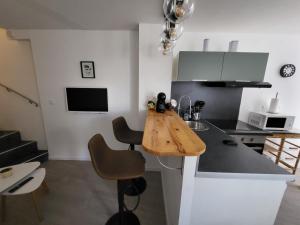 a kitchen with a wooden counter top in a room at T2 meublé La Souterraine in La Souterraine