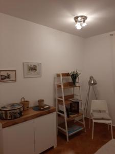 a room with a shelf and a table and a chair at Apartment Yes in Zadar