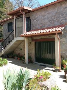 a house with a green garage door and stairs at Casa Bolero in Ferreira