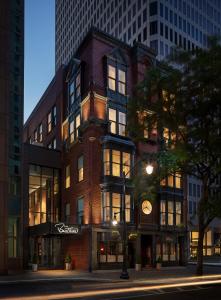 a tall brick building with a clock on it at The Beatrice in Providence