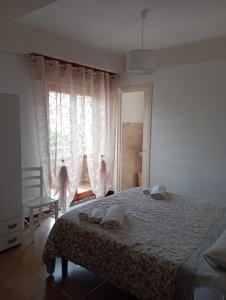 a bedroom with a bed with two towels on it at B&B La Maison in Canicattì