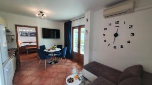 a living room with a clock on the wall at Apartments Anamarija in Opatija
